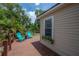 A backyard deck with teal chairs surrounded by lush greenery at 811 W Peninsular St, Tampa, FL 33603
