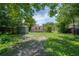 Landscaped backyard with an outdoor storage shed at 811 W Peninsular St, Tampa, FL 33603