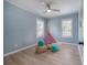 Light blue bedroom with hardwood floors, fan, and teepee at 811 W Peninsular St, Tampa, FL 33603