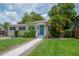Inviting single-story home with lush landscaping and a light blue front door at 811 W Peninsular St, Tampa, FL 33603