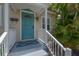 A detailed view of the entry, complete with a light fixture, blue doormat, and charming blue door at 811 W Peninsular St, Tampa, FL 33603