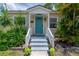 Inviting front porch with a teal door and manicured landscaping at 811 W Peninsular St, Tampa, FL 33603