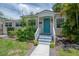 Close-up of the house entrance, showcasing a decorative light blue door and well-kept landscaping at 811 W Peninsular St, Tampa, FL 33603