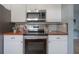 Modern kitchen boasts stainless steel appliances, white cabinetry, and butcher block counters for a stylish touch at 811 W Peninsular St, Tampa, FL 33603
