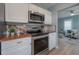Well-equipped kitchen featuring stainless steel appliances, white cabinets, and butcher block countertops at 811 W Peninsular St, Tampa, FL 33603