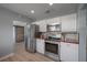 Updated kitchen featuring stainless steel appliances, white cabinets, butcher block countertops, and wood flooring at 811 W Peninsular St, Tampa, FL 33603