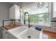 Close-up of a well-lit kitchen sink with a farmhouse-style basin, butcher block countertop, and modern faucet at 811 W Peninsular St, Tampa, FL 33603