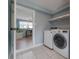 Laundry room featuring new washer/dryer and access to another room at 811 W Peninsular St, Tampa, FL 33603