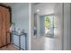 Mud room features a washer/dryer, decor table and a door to the outdoor deck at 811 W Peninsular St, Tampa, FL 33603