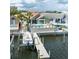 A waterfront home with a private pool, boat dock, and lush landscaping at 835 Symphony Isles Blvd, Apollo Beach, FL 33572