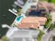 Stunning aerial view showcases private pool and boat dock on the water at 835 Symphony Isles Blvd, Apollo Beach, FL 33572