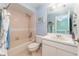 Cozy bathroom featuring a pink tiled shower/tub, vanity, and soft lighting at 835 Symphony Isles Blvd, Apollo Beach, FL 33572