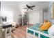 Comfortable bedroom featuring laminate flooring, bookcase, and well-lit desk and chair at 835 Symphony Isles Blvd, Apollo Beach, FL 33572