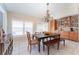 Traditional dining room featuring a chandelier, wood table, and built-in cabinets at 835 Symphony Isles Blvd, Apollo Beach, FL 33572