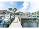 Modern waterfront home with a private dock and boat, perfect for enjoying the beautiful water views and recreational activities at 835 Symphony Isles Blvd, Apollo Beach, FL 33572