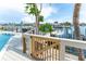 Waterfront deck featuring access to a boat lift, canal access, and outdoor seating at 835 Symphony Isles Blvd, Apollo Beach, FL 33572