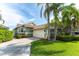 Green exterior with a paved driveway and well manicured front lawn at 835 Symphony Isles Blvd, Apollo Beach, FL 33572