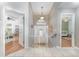 Inviting foyer featuring tile flooring and a decorative front door with sidelights, leading to various rooms of the home at 835 Symphony Isles Blvd, Apollo Beach, FL 33572
