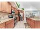 Well-lit kitchen featuring wood cabinets, stainless steel appliances, and granite countertops at 835 Symphony Isles Blvd, Apollo Beach, FL 33572