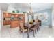 Open-concept kitchen with granite counters, stainless steel appliances, a center island, and a dining area nearby at 835 Symphony Isles Blvd, Apollo Beach, FL 33572