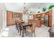 Open kitchen and dining area boasting beautiful wood cabinetry and modern stainless steel appliances at 835 Symphony Isles Blvd, Apollo Beach, FL 33572