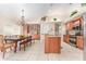 Spacious kitchen with granite countertops, stainless steel appliances, tile flooring, and a dining area with a chandelier at 835 Symphony Isles Blvd, Apollo Beach, FL 33572