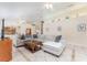 Bright living room with tile flooring, a comfortable sectional sofa, and elegant decor, creating a welcoming atmosphere at 835 Symphony Isles Blvd, Apollo Beach, FL 33572