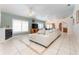 Comfortable living area features tile flooring, a large sofa, a fireplace, and a view into the kitchen at 835 Symphony Isles Blvd, Apollo Beach, FL 33572