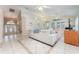 Open living area with tile floors, a large sectional sofa, and an entryway with a decorative door at 835 Symphony Isles Blvd, Apollo Beach, FL 33572