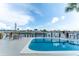Tranquil backyard with a refreshing pool overlooking the canal, complete with comfortable seating and a picturesque view at 835 Symphony Isles Blvd, Apollo Beach, FL 33572