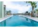 Relaxing pool area with a clear blue pool, waterfront views, and comfortable seating, perfect for leisure and relaxation at 835 Symphony Isles Blvd, Apollo Beach, FL 33572