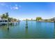 Scenic waterfront view framed by dock pilings, inviting you to experience the tranquil beauty and boating opportunities of this location at 835 Symphony Isles Blvd, Apollo Beach, FL 33572
