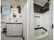 Compact bathroom with black and white tiling, vanity, and shower area, showcasing efficient design at 842 S Boulevard, Tampa, FL 33606