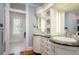 Elegant bathroom with dual sinks, marble countertop, custom cabinets, and an open doorway to the bathtub area at 842 S Boulevard, Tampa, FL 33606