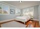 Bright bedroom with hardwood floors, large windows, and a cozy, neutral color scheme at 842 S Boulevard, Tampa, FL 33606