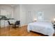 Bright studio apartment with hardwood floors, a compact kitchen, and a cozy sleeping area at 842 S Boulevard, Tampa, FL 33606