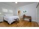 Bright bedroom features a queen bed, desk, ensuite closet, and light hardwood floors at 842 S Boulevard, Tampa, FL 33606