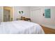 Bedroom with a view into the bathroom and a closet, along with light hardwood floors at 842 S Boulevard, Tampa, FL 33606