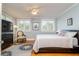 Bright bedroom with a queen bed, ceiling fan, wood floors, and abundant natural light at 842 S Boulevard, Tampa, FL 33606