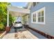 Carport area showcasing a modern vehicle, with an inviting home exterior and well-maintained landscaping at 842 S Boulevard, Tampa, FL 33606