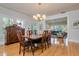 Dining room with hardwood floors and chandelier, next to the living room space at 842 S Boulevard, Tampa, FL 33606