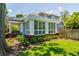 Charming home featuring a sunroom addition, manicured lawn, and mature trees at 842 S Boulevard, Tampa, FL 33606