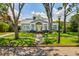 Charming single-story home with a landscaped front yard, sidewalk, and inviting yellow front door at 842 S Boulevard, Tampa, FL 33606