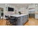 Well-appointed kitchen featuring a large island with seating, custom cabinets, stainless appliances, and hardwood floors at 842 S Boulevard, Tampa, FL 33606
