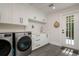 Modern laundry room equipped with high-end washer and dryer, storage cabinets, and convenient sink area at 842 S Boulevard, Tampa, FL 33606