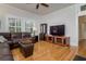 Cozy living room with hardwood floors, large windows, and comfortable brown leather sofa at 842 S Boulevard, Tampa, FL 33606