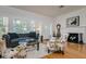 Living room with hardwood floors, white-painted brick fireplace, and lots of natural light at 842 S Boulevard, Tampa, FL 33606
