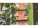 Aerial view showcasing terracotta roofs, lush landscaping, and screened pools in a neighborhood at 8476 Dunham Station Dr, Tampa, FL 33647