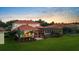 Beautiful home's aerial view highlighting the pool, patio, and expansive lawn within a lush, established neighborhood at 8476 Dunham Station Dr, Tampa, FL 33647