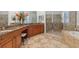 Spacious bathroom featuring a double vanity, glass shower, and a soaking tub at 8476 Dunham Station Dr, Tampa, FL 33647